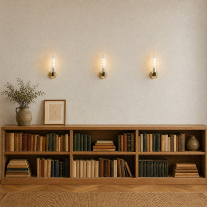Trois appliques murales cristal alignées et allumées au-dessus d'un rayonnage de chêne, couloir bibliothèque | Delvanie