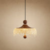 Petite suspension Aubine, chapeau de bois teinté noyer et frange d'acrylique givré, allumée | Delvanie